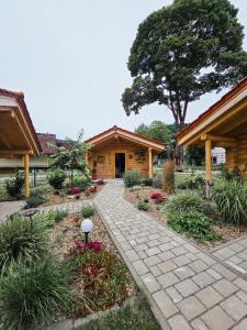 a stone walkway in front of a log cabin at Chalet Hüttendorf 49 gradnord in Bayerisch Eisenstein +8 photos