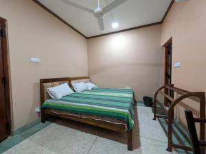a bedroom with a bed in a room at Seethevi Hotels in Batticaloa