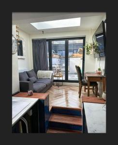 a living room with a couch and a table at Spacious House In Guildford in Stoughton