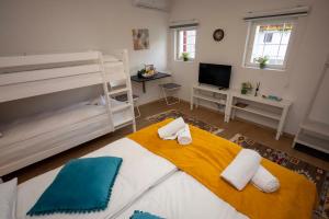 a bedroom with a large bed and a television at Bosanska Avlija Authentic Sarajevo Stay with Garden in Sarajevo