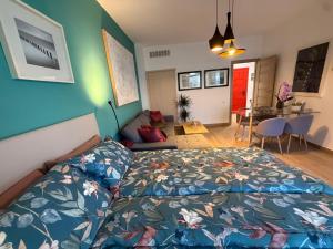 a bedroom with a bed and a blue wall at La Roca Sea View Luxury Apartment Beach Elevator in Torremolinos