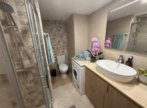 a bathroom with a sink and a washing machine at La Roca Sea View Luxury Apartment Beach Elevator in Torremolinos +29 photos