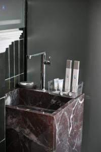 a bathroom with a marble sink with a faucet at Hotel Bel Ami Tirana in Tirana +74 photos