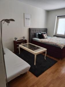a room with two beds and a coffee table at Karl Cozy stay in Örebro