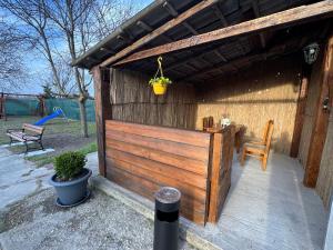 a wooden shed with a table and a chair at Apartment PMS in Veľká Mača
