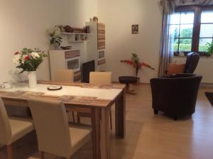 a dining room with a table and chairs at Ferienwohnung Sonne-Stadtrand Dresden in Moritzburg +22 photos