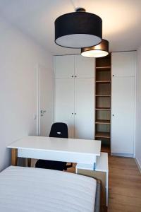 a room with a white desk and a bed at Sami Swoi 1 in Bełchatów