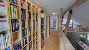 a hallway with wooden shelves filled with books at Hearts Home Hahnenklee in Hahnenklee-Bockswiese