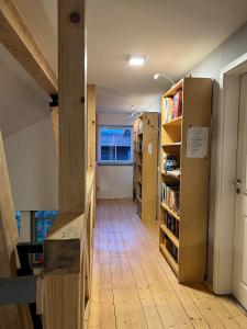 a hallway with bookshelves and a library with a window at Hearts Home Hahnenklee in Hahnenklee-Bockswiese