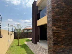 an external view of a house with a brick wall at Zabo Guesthouse in Middelburg