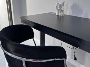 a black chair sitting in front of a desk at Zabo Guesthouse in Middelburg
