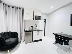 a living room with a black chair and a desk at Zabo Guesthouse in Middelburg