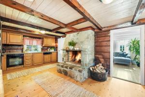 a living room with a stone fireplace in a house at Det Hvite Hus - Fosseland Hytter in Feda