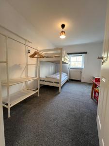 a bedroom with two bunk beds and a window at Hearts Home Hahnenklee in Hahnenklee-Bockswiese