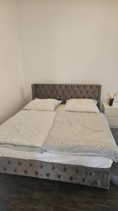 a bed in a bedroom with a bed frame at Die Schöne Wohnung am Stade Bahnof in Stade +9 photos