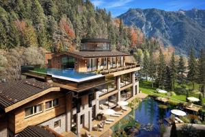 an aerial view of a house with a pool at Chalets Grossmitt in Pertisau