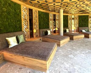 a room with three beds and a green wall at Chalets Grossmitt in Pertisau