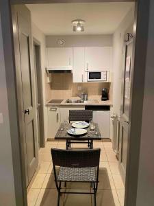 a small kitchen with a table and two chairs at Cosy Residence, The Verbier Residences in Verbier