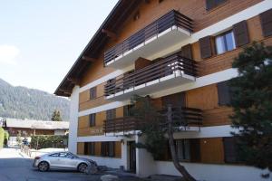 a building with a car parked in front of it at Cosy Residence, The Verbier Residences in Verbier