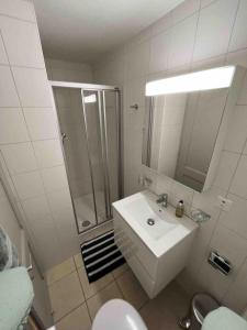 a bathroom with a sink and a shower and a toilet at Cosy Residence, The Verbier Residences in Verbier