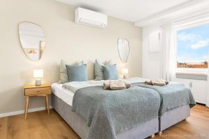a bedroom with a large bed with two mirrors at Bad Aibling Apartments in Bad Aibling