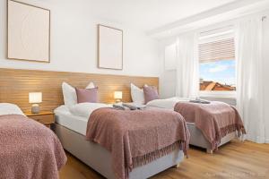 a bedroom with two beds and a window at Bad Aibling Apartments in Bad Aibling