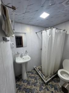 a bathroom with a sink and a toilet and a shower at Garden Palace Khiva in Khiva