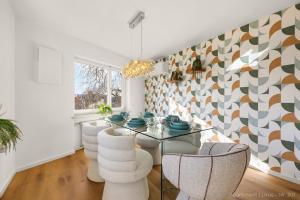 a dining room with a glass table and white chairs at Bad Aibling Apartments in Bad Aibling