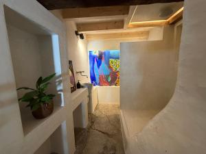 a hallway with a potted plant and a painting at Our Hippie Castle Vianden - Unique Bohemian Guesthouse in Vianden +77 photos