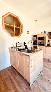 a kitchen with a sink and a counter top at - Magnifique appartement climatisé 92m2, spacieux et cosy, au cœur de Vichy in Vichy