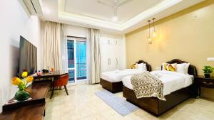 a hotel room with two beds and a television at BluO Medicity - Boutique Hotel Gurgaon in Gurgaon +40 photos