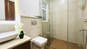 a bathroom with a shower and a toilet and a sink at BluO Medicity - Boutique Hotel Gurgaon in Gurgaon