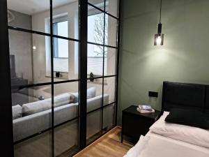 a bedroom with a bed and a tub in a room at Nowe apartamenty SOLAR, Padel & Tenis, Parking, Blisko centrum in Bielsko-Biała +85 photos