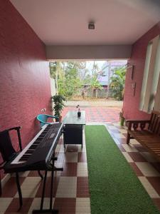 a room with a table and a green carpet at Mud apples in Varkala