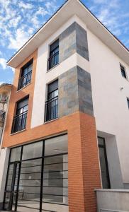 a building with a brick and white at Sentir CAZORLA in Cazorla