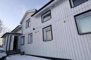 a house with snow on the side of it at Workers Stay - Staff Accommodation Säve - Göteborg in Säve