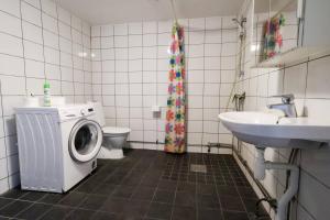 a bathroom with a washing machine and a sink at Workers Stay - Staff Accommodation Säve - Göteborg in Säve