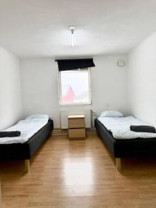 a room with two beds and a window at Workers Stay - Staff Accommodation Säve - Göteborg in Säve
