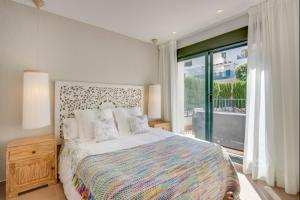 a bedroom with a large bed and a large window at Can Tau Cala Tarida in Sant Josep de sa Talaia