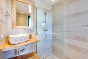 a bathroom with a sink and a glass shower at Can Tau Cala Tarida in Sant Josep de sa Talaia +21 photos