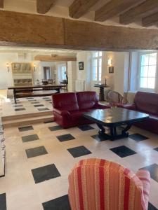 a living room with a couch and a table at Le clos du cèdre in Cellettes +94 photos
