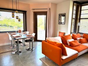 a living room with a couch and a table at Villa Bonheur in Koksijde