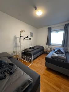 a bedroom with two beds and a window at Linz Wasserwald - cozy 2BR Apartment in Linz