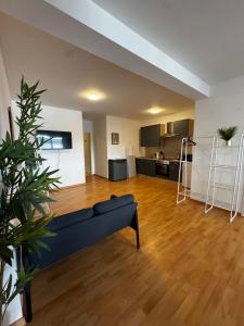 a living room with a couch and a kitchen at Linz Wasserwald - cozy 2BR Apartment in Linz