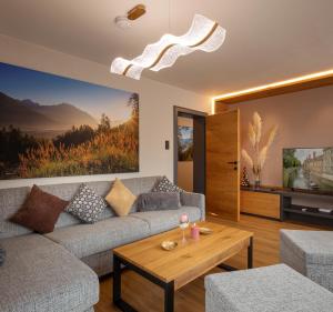 a living room with a couch and a coffee table at Alpenchalet am Lech in Ehenbichl
