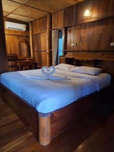 a bedroom with a bed with a heart on it at Tribal Pai in Pai