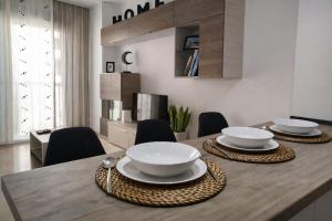 a dining room table with bowls and plates on it at Sentir CAZORLA in Cazorla