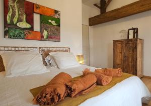 a bedroom with a white bed with pillows on it at Les Anges de la Vigne par Lisca Begay in Biron