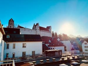 a view of a town with a castle at Schwanstein Apartments Füssen ZENTRUM in Füssen