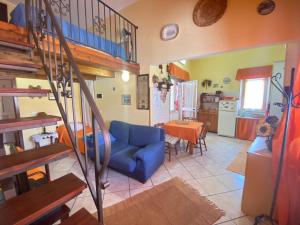 a living room with a blue couch and a table at Baglio Cusenza Rooms in San Vito lo Capo +25 photos